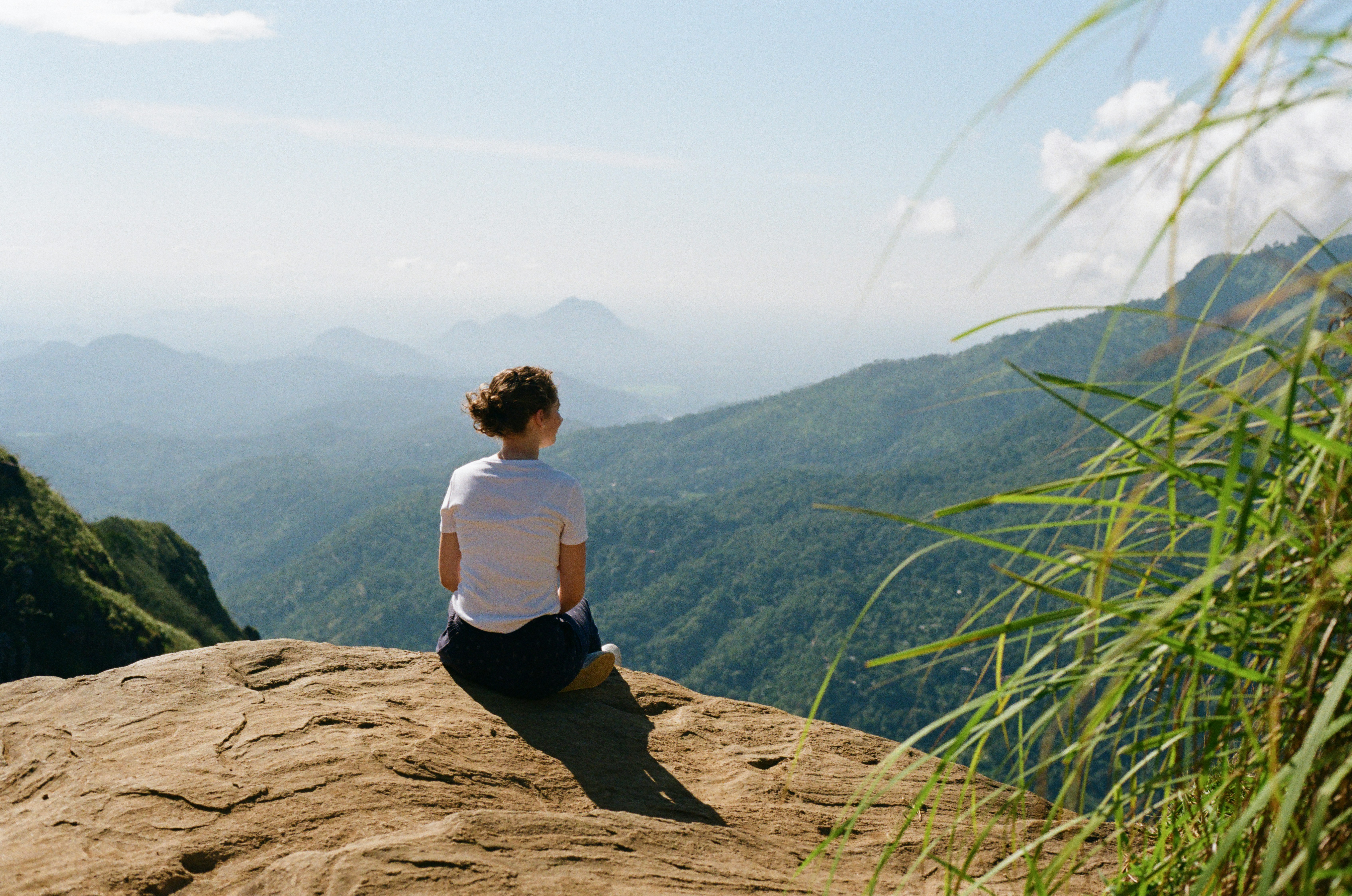 Person contemplating their health journey in peaceful outdoor setting